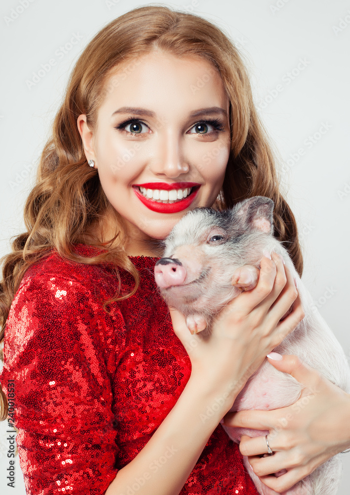 Smiling woman and pig pet. Female model face with makeup and long hair portrait Smiling woman and pig pet. Female model face with makeup and long hair portrait