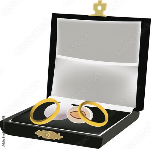 cofanetto con anelli di matrimonio e confetti