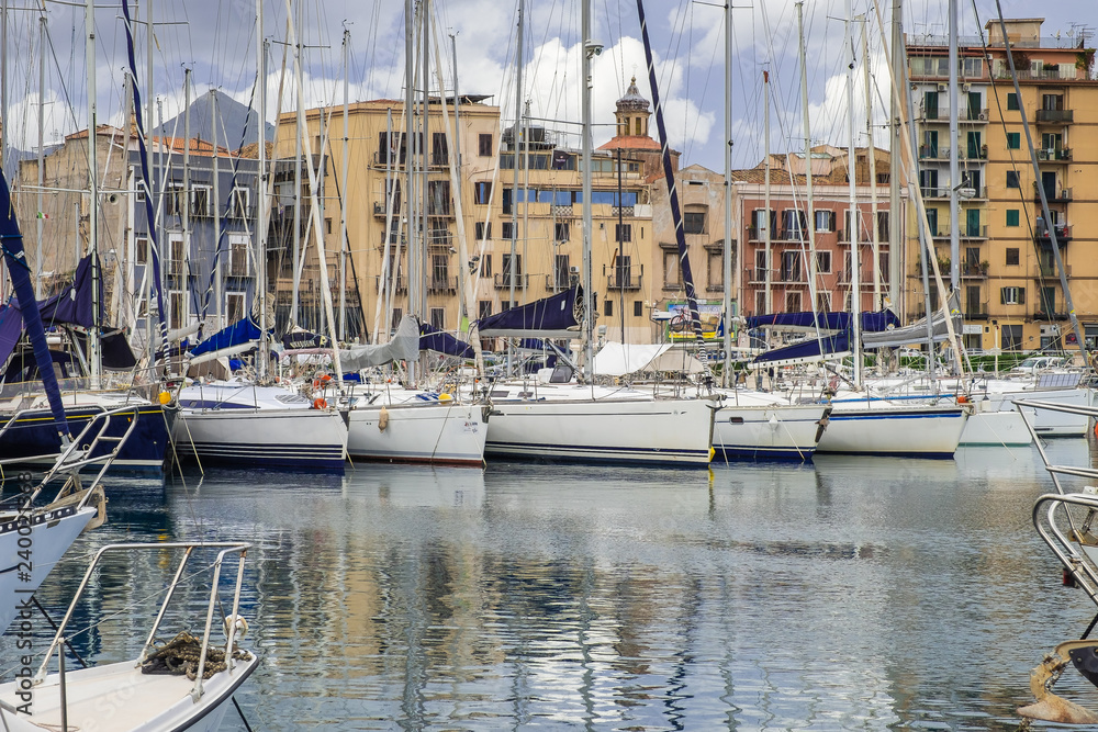 Boats and yachts parked in La Cala bay, old port in Palermo, Sicily.