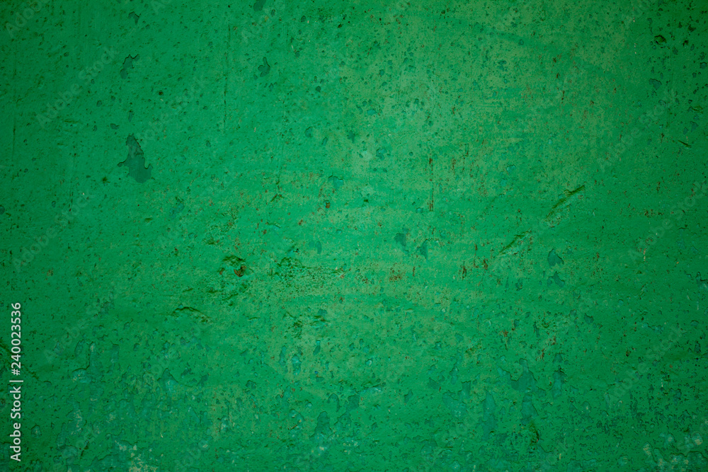 old green damaged wall with scratches and stains of paint. rough surface texture