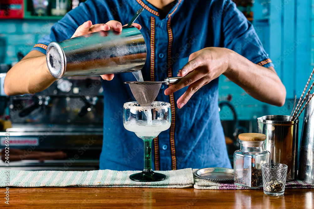 bartender at the bar making a cocktail