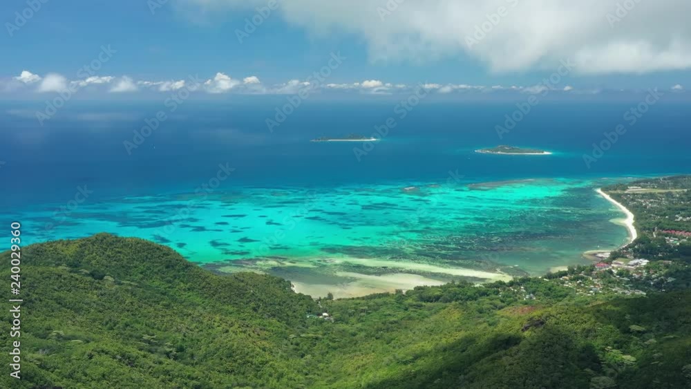 Aerial view of tropical paradise beach with white sand and turquoise crystal clear waters of Indian Ocean - Grand Anse, Praslin Island, Seychelles Aerial view of tropical paradise beach with white sand and turquoise crystal clear waters of Indian Ocean - Grand Anse, Praslin Island, Seychelles
