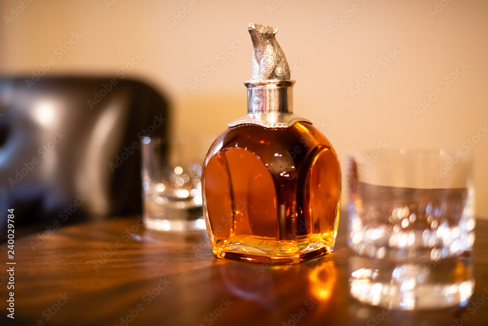 Whiskey Decanter in Library with Leather Chair and Two Glasses Whiskey Decanter in Library with Leather Chair and Two Glasses