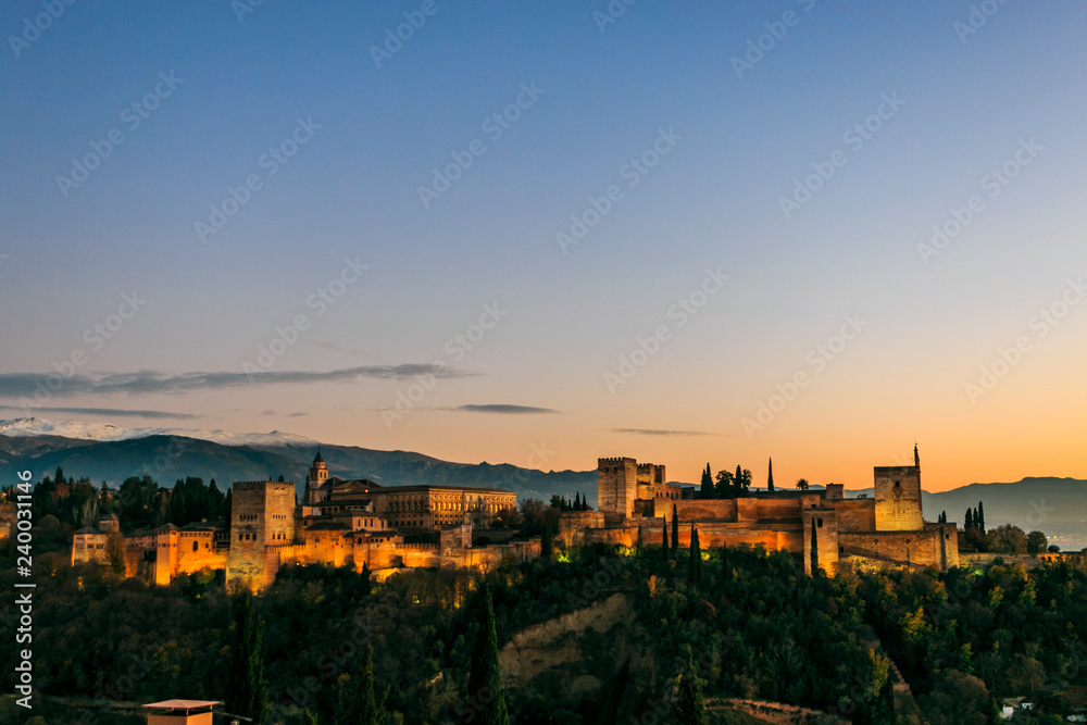 Granada city. Panoramic view of Alhambra palace and fortress with Sierra Nevada at the background. Space for text