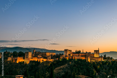 Granada city. Panoramic view of Alhambra palace and fortress with Sierra Nevada at the background. Space for text