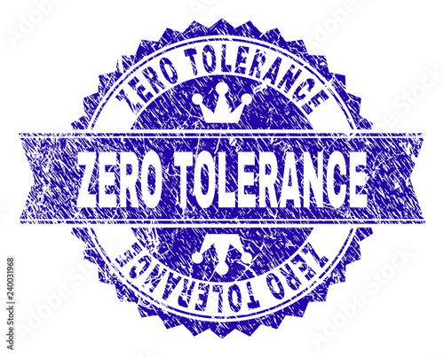 ZERO TOLERANCE rosette stamp seal overlay with grunge texture. Designed with round rosette, ribbon and small crowns. Blue vector rubber print of ZERO TOLERANCE label with grunge texture.