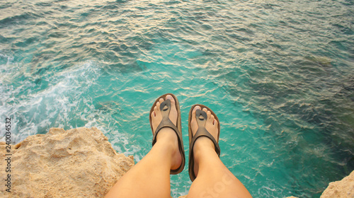 Feet hanging over sea cliffs
