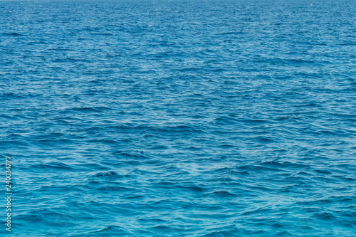 Blue sea background. Blue sea surface with waves.