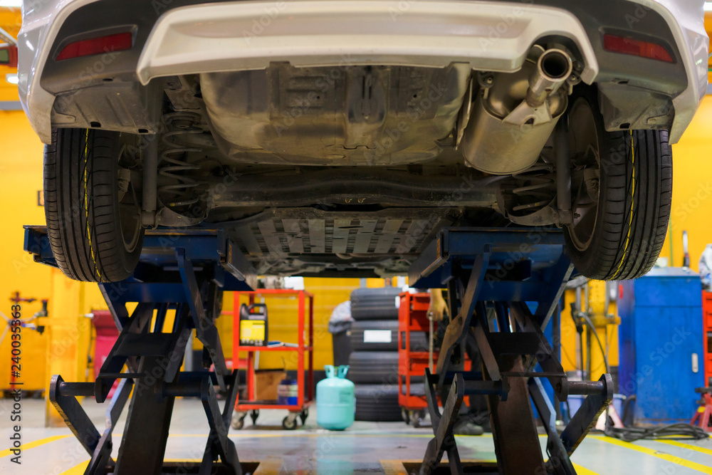 Fototapeta premium The car on the lift prepared to repair