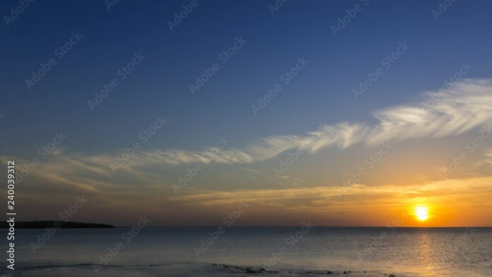 4k timelapse clouds crossing the amazing sky over the sea or ocean at sunset. Sun rays emerge through the clouds. The clouds cross slowly from right to left and appear to be orange blue and purple. 4k timelapse clouds crossing the amazing sky over the sea or ocean at sunset. Sun rays emerge through the clouds. The clouds cross slowly from right to left and appear to be orange blue and purple.