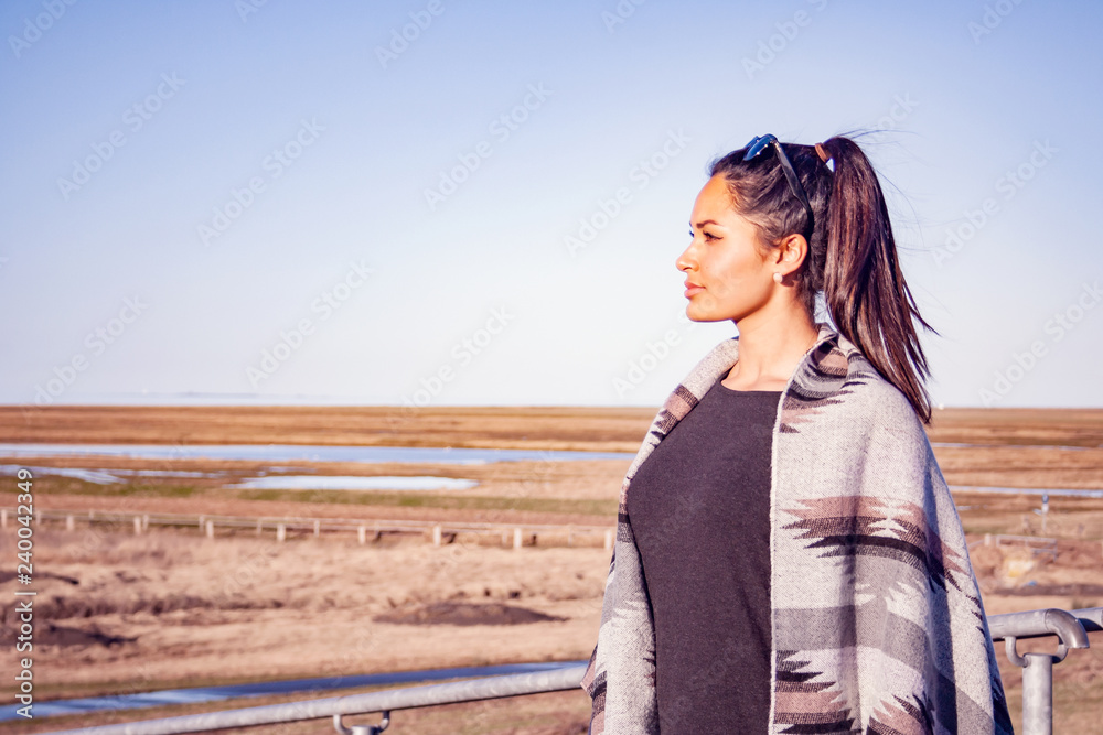 Young female model with tunic in front of the fields in Northern Germany. Young female model with tunic in front of the fields in Northern Germany.