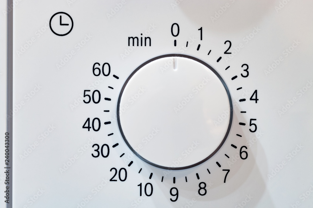 Microwave oven circular timer for one hour, analogue white. Stock Photo