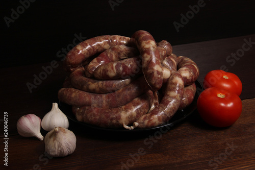 fragrant homemade german sausage cabbage links with meat grinder lay on a plate on wooden table. Sausage allowed with keto diet