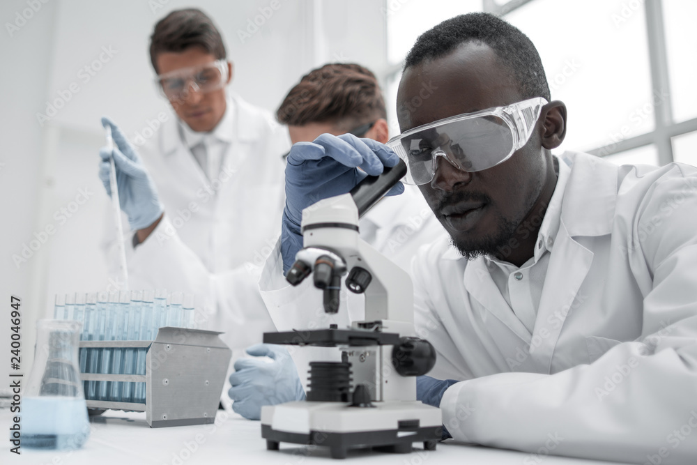 modern scientist looking through a microscope modern scientist looking through a microscope