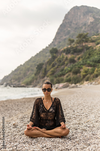 Summer lifestyle. Female meditating in a beautiful bay © Saida
