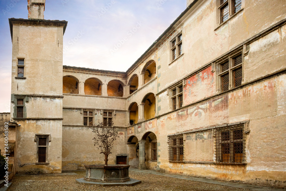 Issogne: Castle of Issogne. The courtyard with the pomegranate fountain. Val D'aosta, Italy.