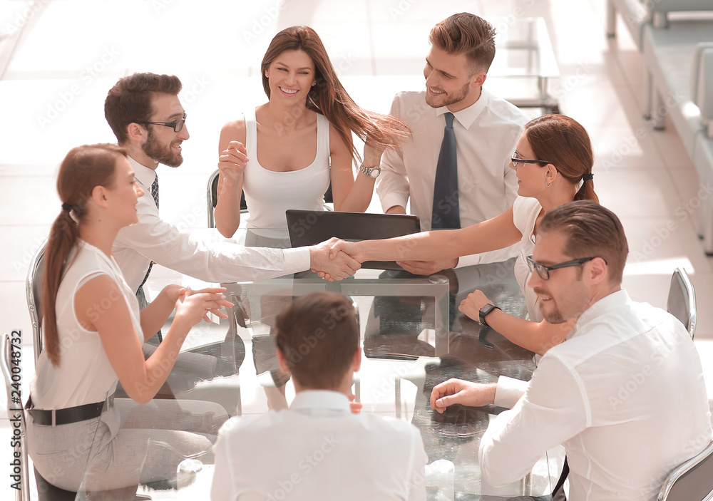 handshake business partners at the negotiating table handshake business partners at the negotiating table