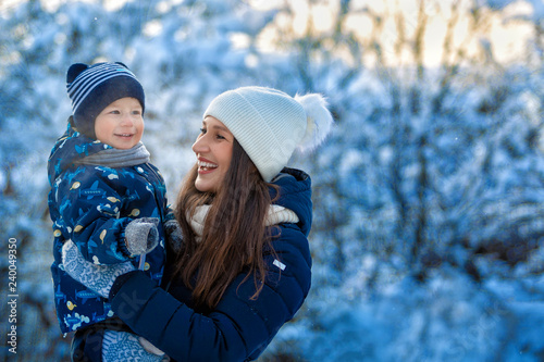 Woman and child in winter in nature. Portrait of a happy family