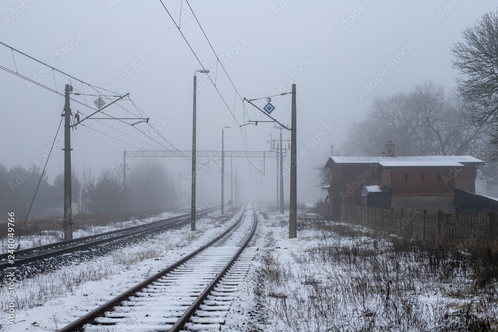 Railway tracks in the fog. A route connecting towns in central Europe.