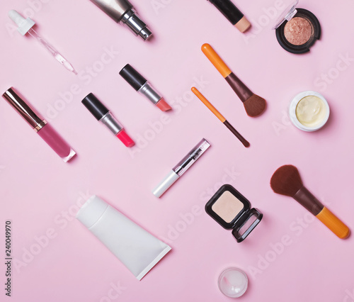 Brushes and make-up produts on the pink backgound