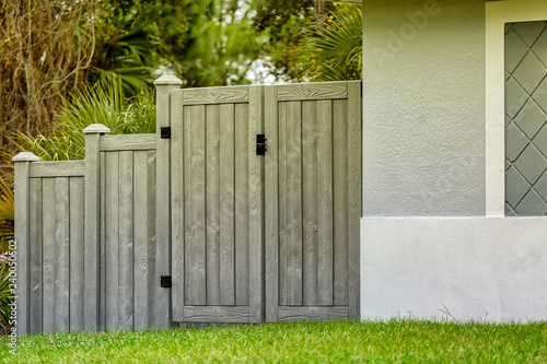 Fototapeta Naklejka Na Ścianę i Meble -  Double Gates of Gray Composite Fence