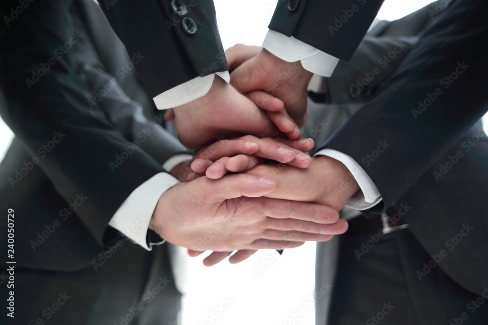 Close-up of businesspeople stacking hands in meeting Close-up of businesspeople stacking hands in meeting