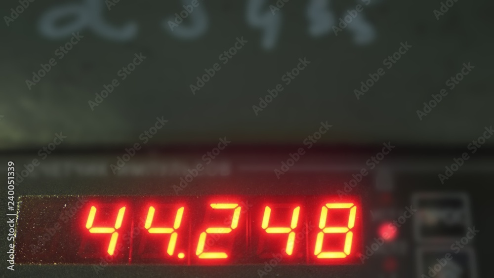 Fototapeta premium Electronic digital dial meter counter pipe. Manufacture of plastic water pipes of the factory. Process of making plastic tubes on the machine tool with the use of water and air pressure.