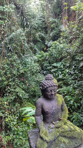 An ancient statue in a forest.