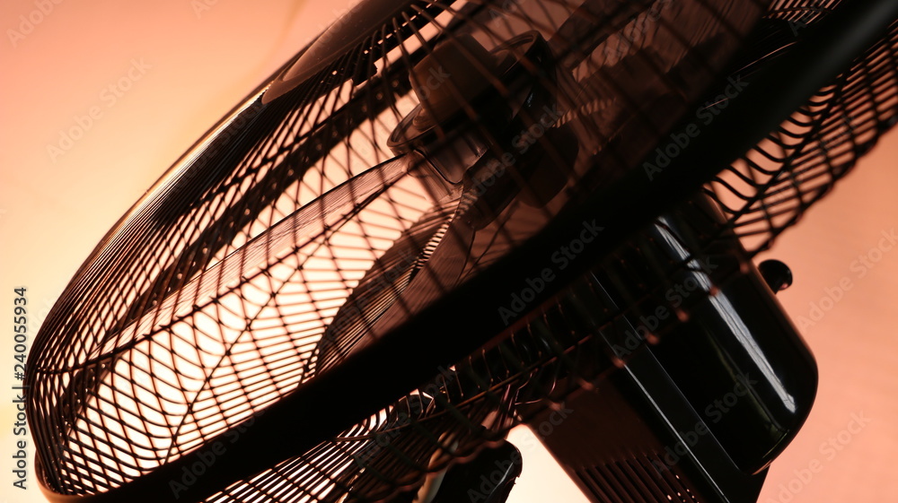 Close up of a spinning domestic fan blades Close up of a spinning domestic fan blades