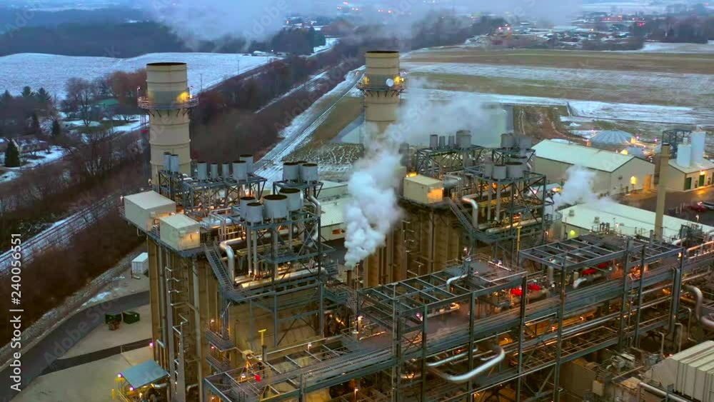 Aerial view of modern power plant at twilight with lights and emissions. Aerial view of modern power plant at twilight with lights and emissions.