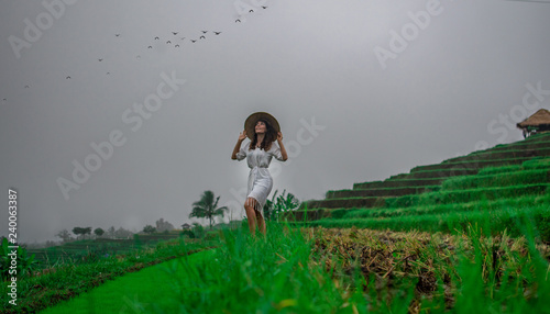 Pretty Girl with conical asian hat in rice fields on Bali, Indonesia