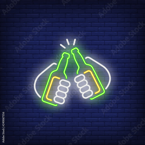 Two hands holding and clinking beer bottles neon sign. Party design element. Night bright neon sign, colorful billboard, light banner. Vector illustration in neon style.