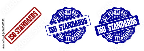ISO STANDARDS scratched stamp seals in red and blue colors. Vector ISO STANDARDS labels with scratced texture. Graphic elements are rounded rectangles, rosettes, circles and text labels.
