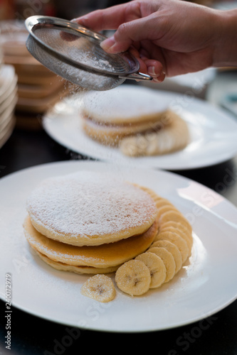 homemade pancake with bananas and sugar.