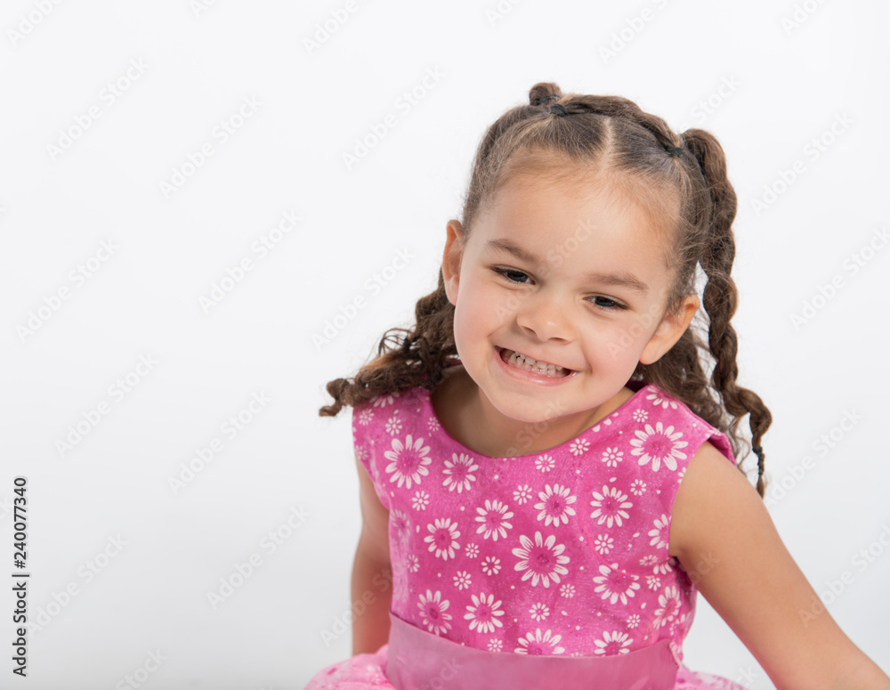 Close up of mixed race little girl dancing on white background Close up of mixed race little girl dancing on white background