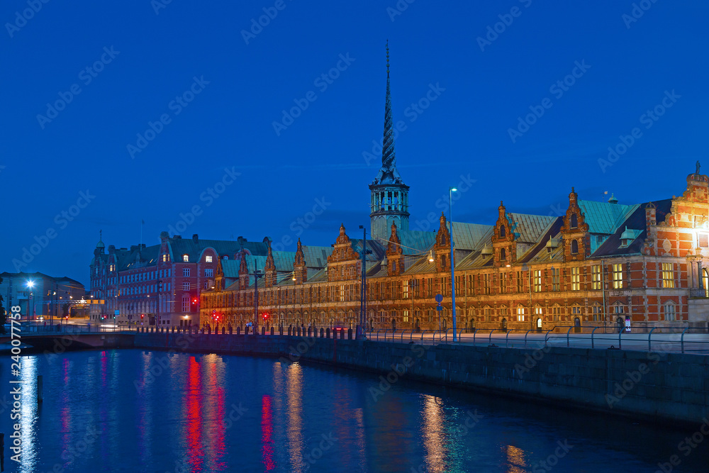 Old Stock Exchange building in central Copenhagen at night. Danish renaissance building near the water in Denmark capital city of Copenhagen.