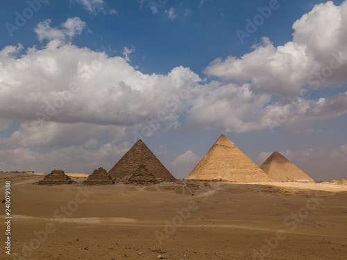 Great Pyramids of Egypt on a beautiful day with blue sky and white clouds