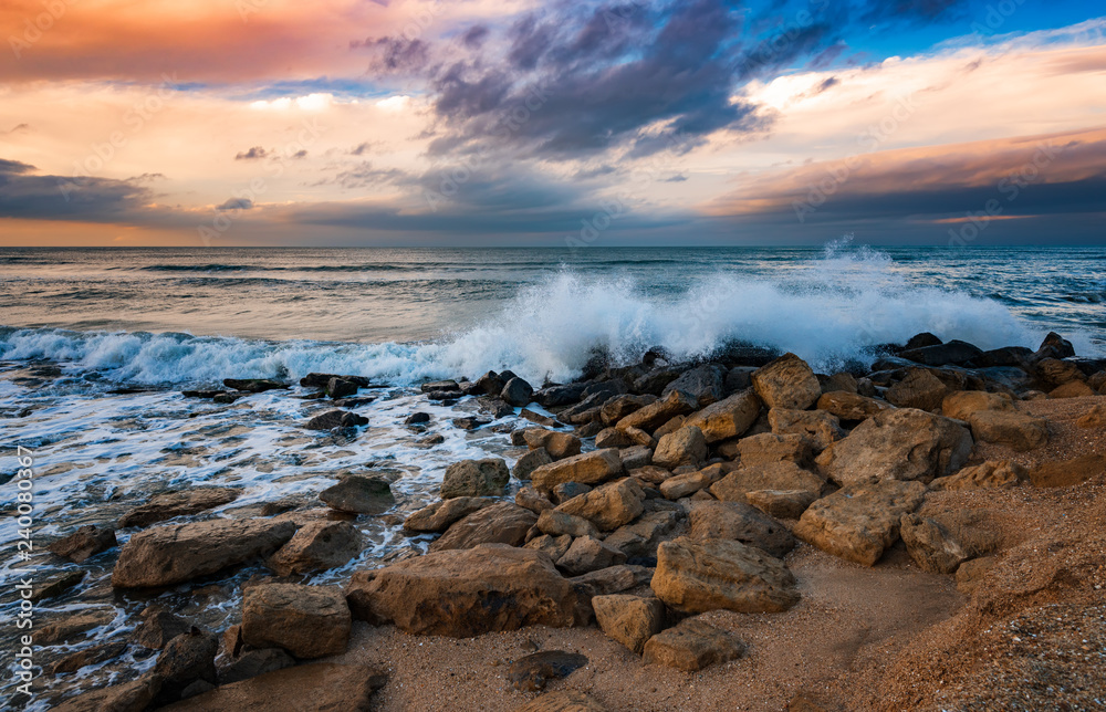 Fototapeta premium Seashore with cliffs, waves crashing on rocks