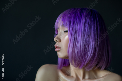 Woman in colorful bright lights posing in studio, portrait of beautiful sexy girl with trendy make-up and bright hair.