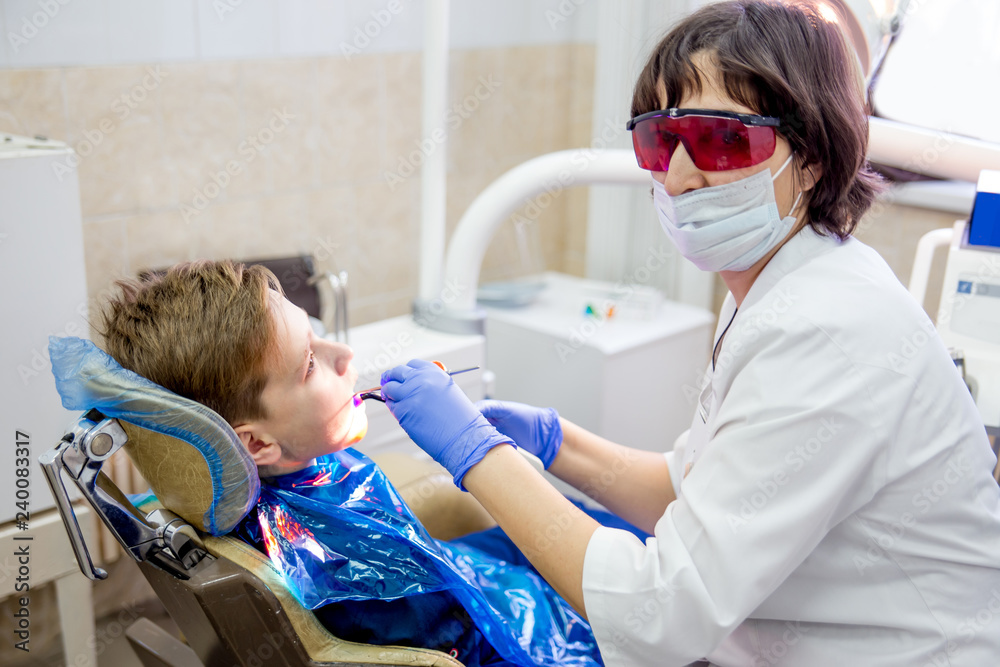 female dentist with a patient in a clinic female dentist with a patient in a clinic