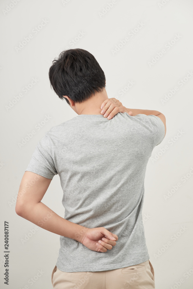Man rubbing his painful back close up. Business man holding his lower back. Pain relief, chiropractic concept