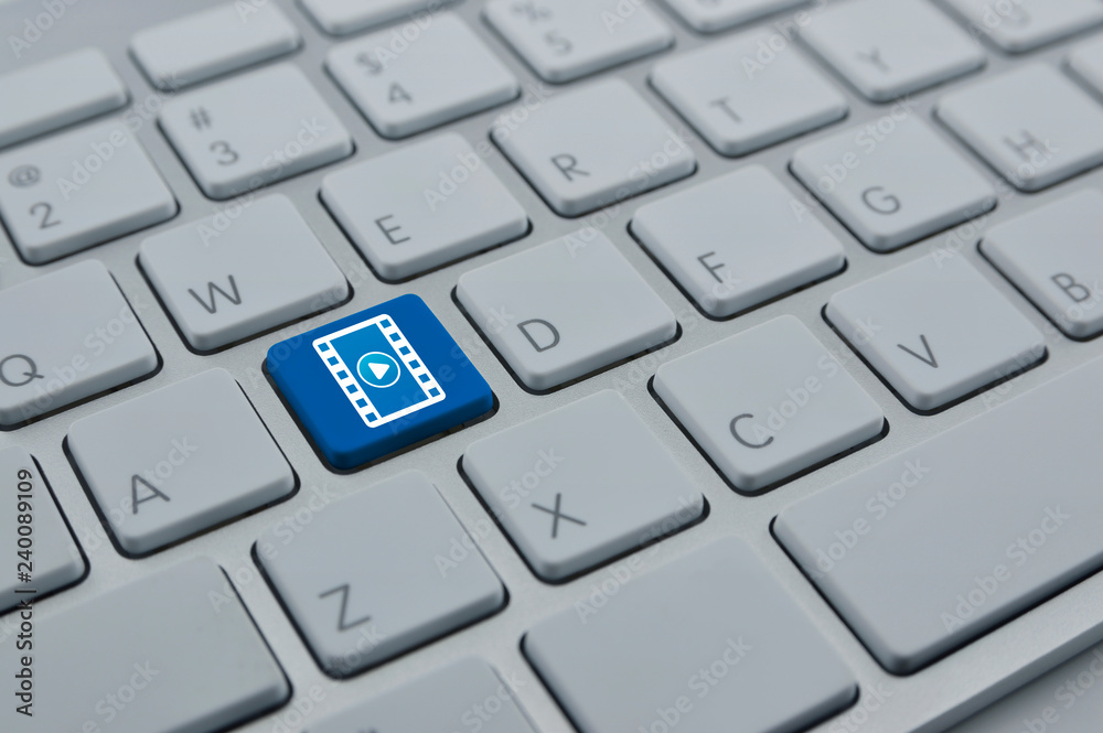 Play button with movie film icon on modern computer keyboard button, Business cinema online concept Play button with movie film icon on modern computer keyboard button, Business cinema online concept