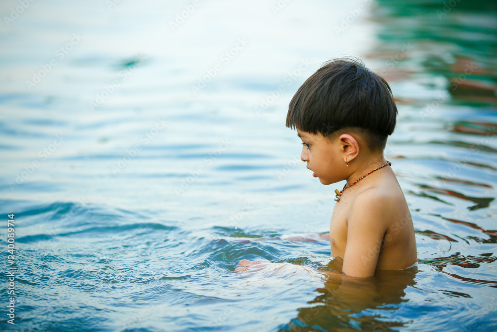 Indian child playing in water
