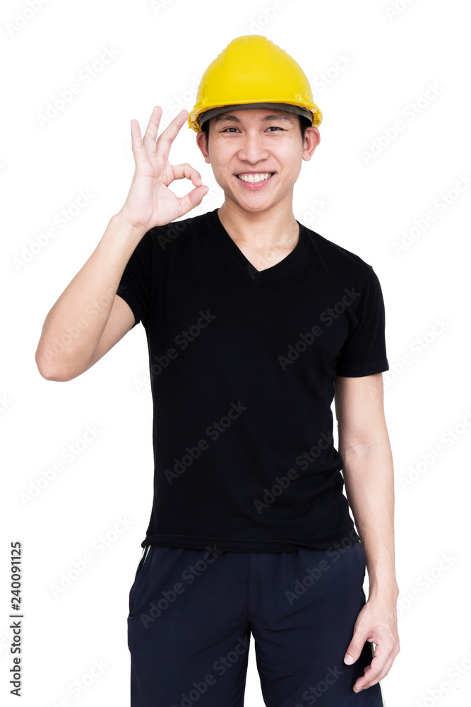 Young handsome asian engineer with yellow helmet is showing okay sign with happiness. He is smiling and looking forward with joy. Isolated on white background.