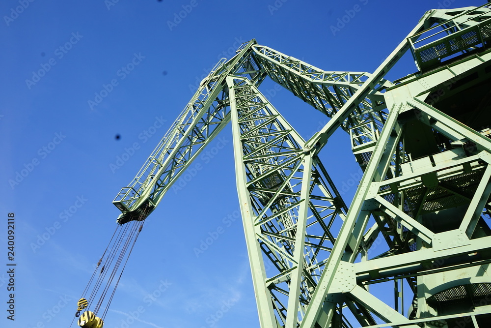 Industrial crane against blue sky