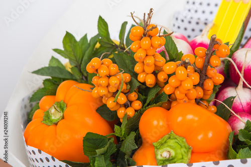 Unusual bouquet of flowers  fruits and vegetables. The concept of edible bouquet for children