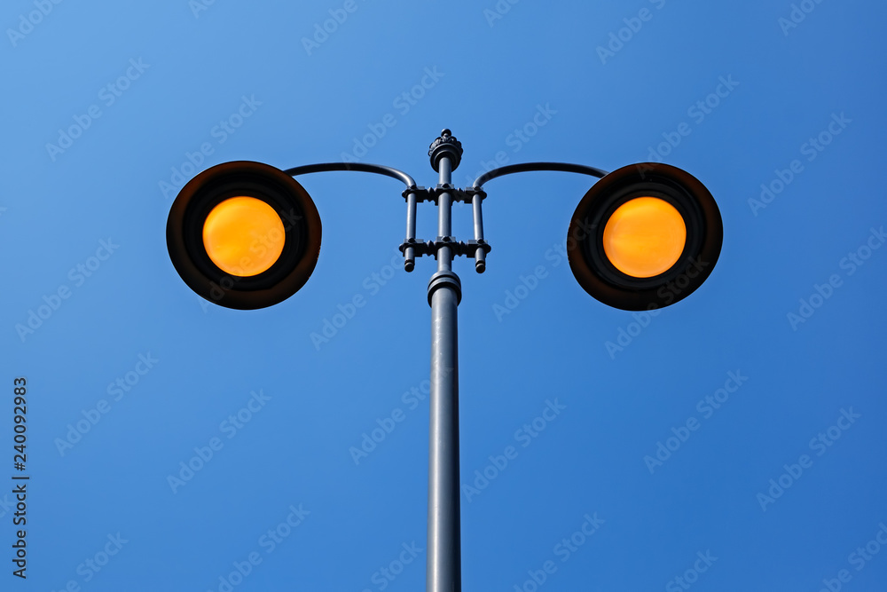 yellow lighting street poles on blue sky yellow lighting street poles on blue sky