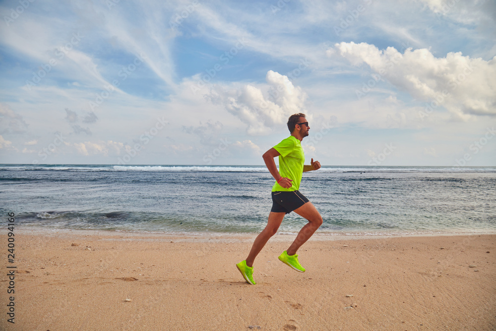Man running / jogging on a tropical exotic beach. Man running / jogging on a tropical exotic beach.