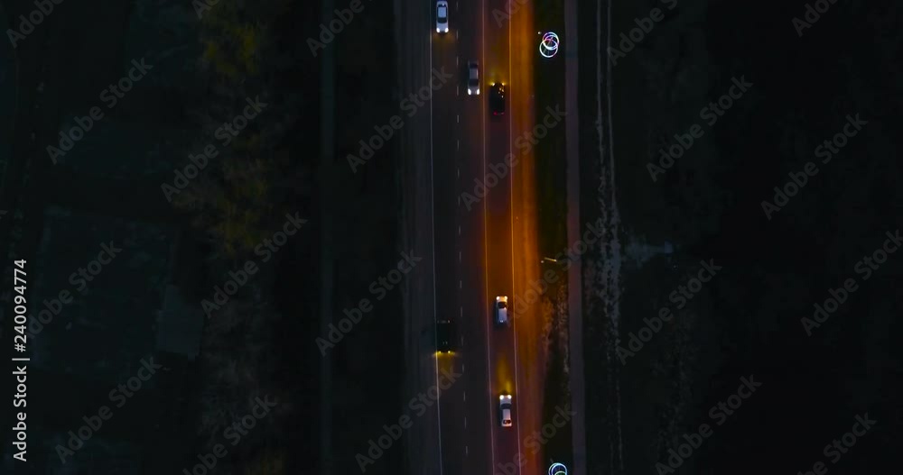 Flying over the roadway with cars at night. Beautiful aerial view on the night road. Flying over the roadway with cars at night. Beautiful aerial view on the night road.