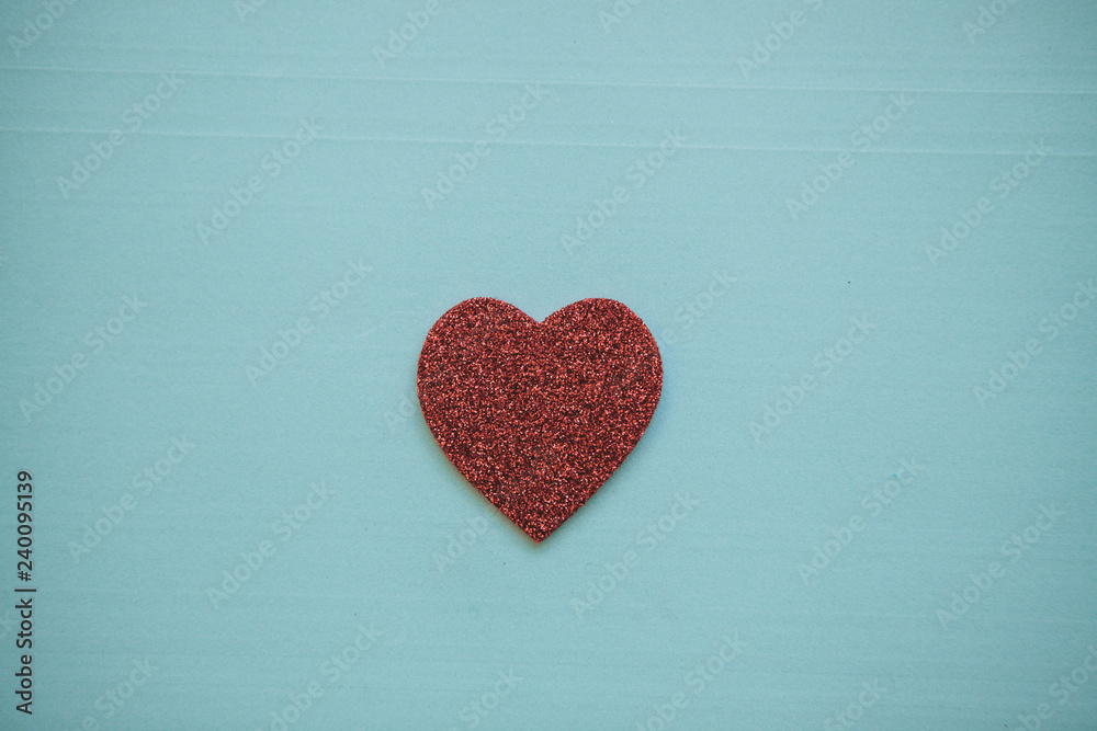 Obraz premium Red heart on a blue background. Concept for Valentine's Day or Women's Day or the topic of health, life, donation and help. In minimal style.